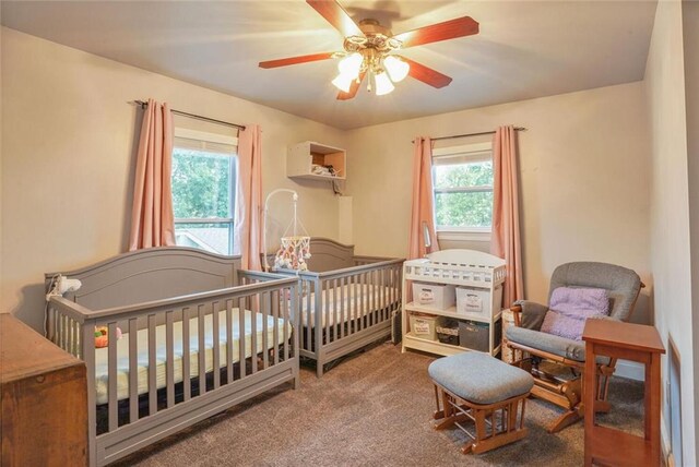 700 Kent Ave, Metairie, LA 70001 - bedroom with multiple windows, carpet floors, ceiling fan, and a nursery area