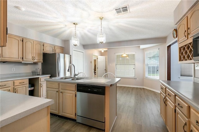 602 Willowdale Blvd, Luling, LA 70070 - kitchen featuring appliances with stainless steel finishes, a sink, light brown cabinets, dark wood-type flooring, and a textured ceiling
