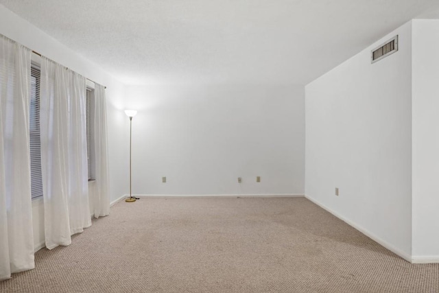 empty room with light carpet and baseboards