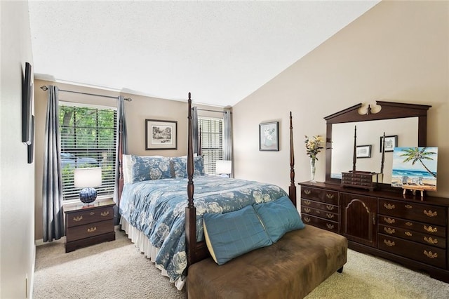 bedroom with light colored carpet, vaulted ceiling, and multiple windows