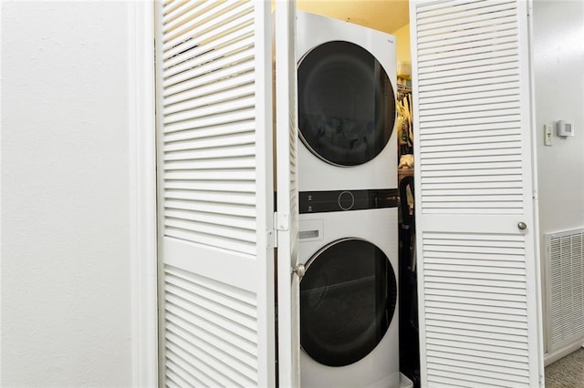 laundry area with stacked washer / dryer