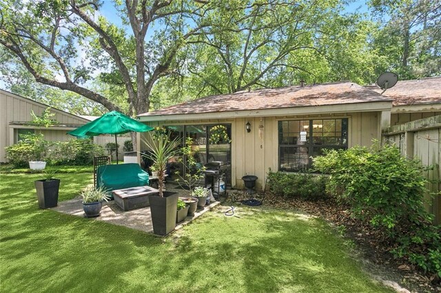 rear view of property featuring board and batten siding