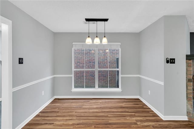 3737 James Victor Dr, Baton Rouge, LA 70817 - unfurnished dining area featuring wood finished floors, baseboards, and a chandelier