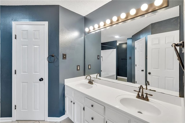 3737 James Victor Dr, Baton Rouge, LA 70817 - full bath with a tub, double vanity, a shower, a textured wall, and baseboards