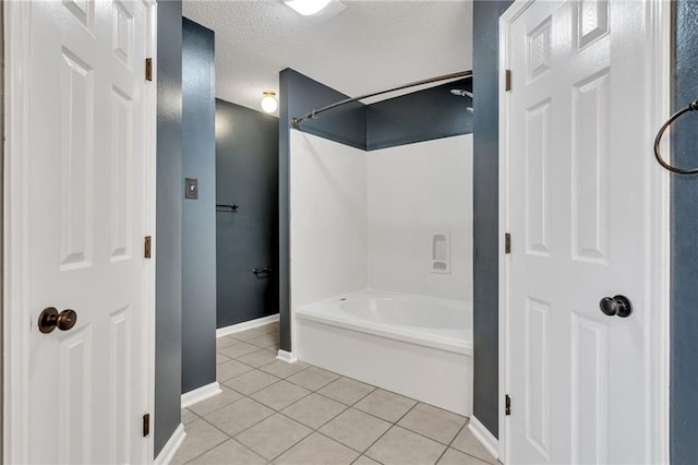 3737 James Victor Dr, Baton Rouge, LA 70817 - bathroom featuring tile patterned flooring, a textured ceiling, baseboards, and tub / shower combination