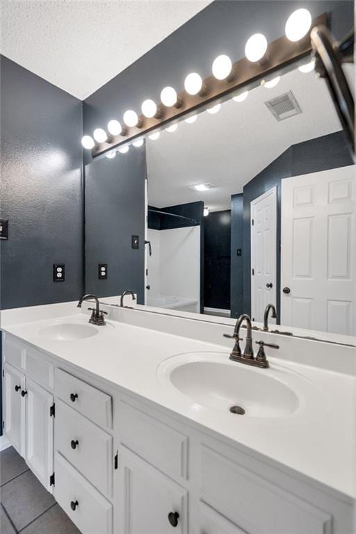 3737 James Victor Dr, Baton Rouge, LA 70817 - bathroom featuring a shower, tile patterned floors, and double vanity