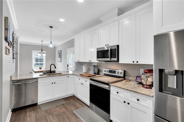 3986 Main St, Zachary, LA 70791 - kitchen with stainless steel appliances, a sink, dark wood-type flooring, crown molding, and tasteful backsplash