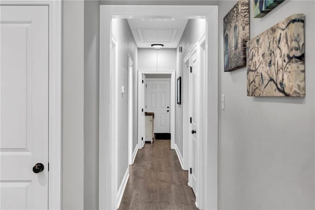 3986 Main St, Zachary, LA 70791 - hallway featuring attic access, dark wood finished floors, and baseboards