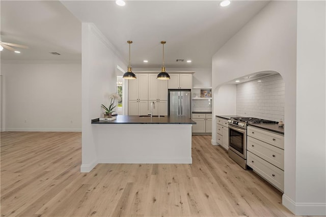212 Highland Oak N, Madisonville, LA 70447 - kitchen featuring appliances with stainless steel finishes, dark countertops, a sink, backsplash, and recessed lighting