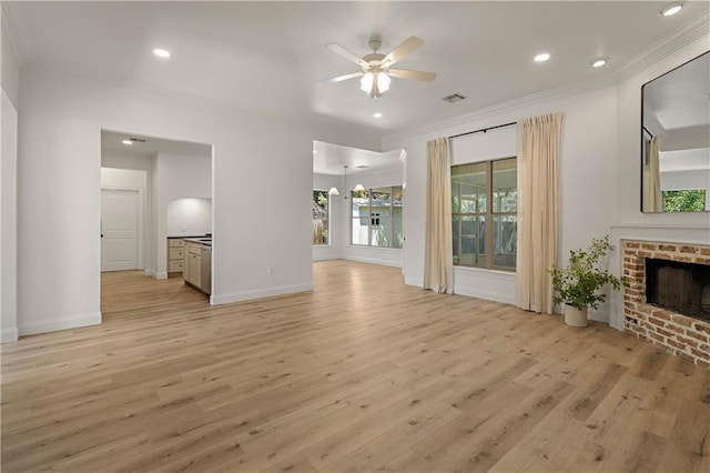 212 Highland Oak N, Madisonville, LA 70447 - unfurnished living room with ornamental molding, ceiling fan, light wood-type flooring, a fireplace, and recessed lighting
