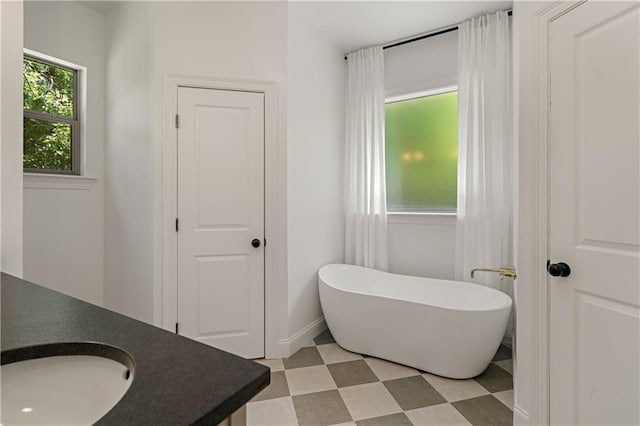 212 Highland Oak N, Madisonville, LA 70447 - full bath featuring a soaking tub, tile patterned floors, vanity, and baseboards