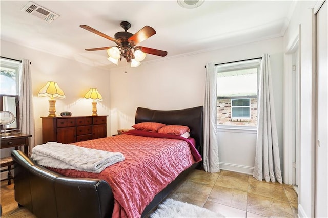 bedroom featuring baseboards, crown molding, and a ceiling fan
