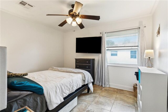 bedroom with crown molding, baseboards, and a ceiling fan