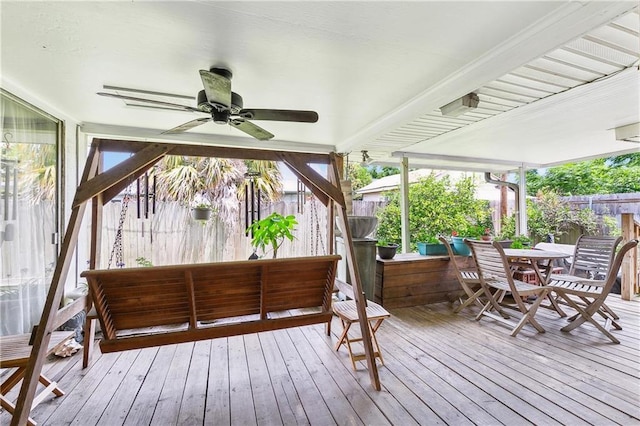 deck featuring outdoor dining space, a ceiling fan, and fence