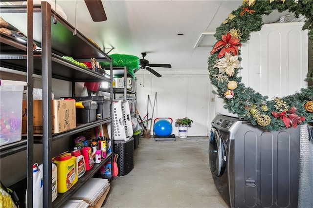 storage room with a ceiling fan and washer / dryer