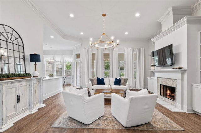 336 Rue St, Emilion, Covington, LA 70433 - living room featuring a chandelier, wood finished floors, recessed lighting, a lit fireplace, and ornamental molding