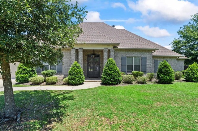 336 Rue St, Emilion, Covington, LA 70433 - view of front of property featuring brick siding, a front lawn, and roof with shingles