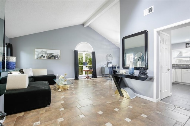 126 Silverwood Dr, Slidell, LA 70461 - living room featuring plenty of natural light, beam ceiling, baseboards, high vaulted ceiling, and stone finish floors