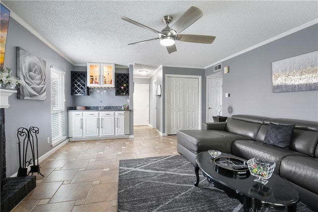 126 Silverwood Dr, Slidell, LA 70461 - living area featuring wet bar, stone tile flooring, ceiling fan, baseboards, and crown molding