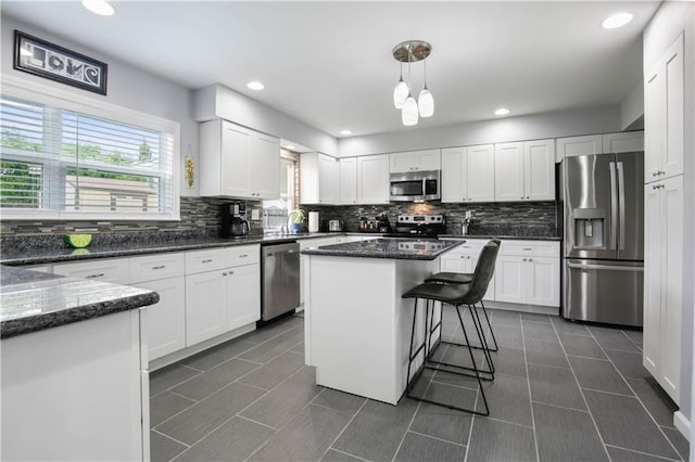 126 Silverwood Dr, Slidell, LA 70461 - kitchen with stainless steel appliances, decorative backsplash, white cabinetry, dark stone counters, and recessed lighting