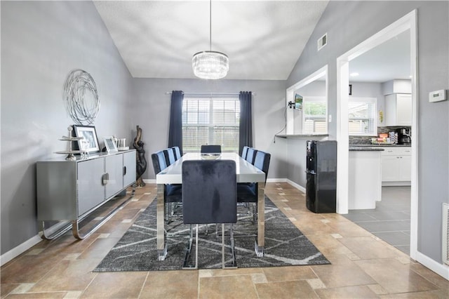 126 Silverwood Dr, Slidell, LA 70461 - dining space featuring vaulted ceiling, a chandelier, and baseboards