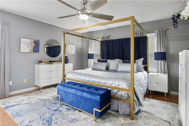 126 Silverwood Dr, Slidell, LA 70461 - bedroom with wood finished floors, baseboards, ceiling fan, and a textured ceiling
