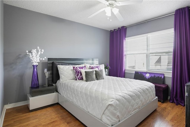 126 Silverwood Dr, Slidell, LA 70461 - bedroom with wood finished floors, a textured ceiling, and a ceiling fan