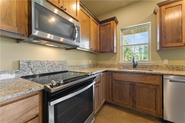 200 Cotton Ln, Hammond, LA 70401 - kitchen with appliances with stainless steel finishes, a sink, and brown cabinets