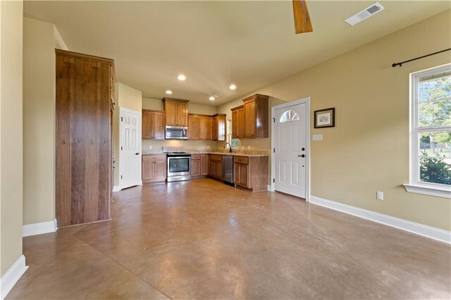 200 Cotton Ln, Hammond, LA 70401 - kitchen with stainless steel appliances, baseboards, concrete flooring, light countertops, and recessed lighting