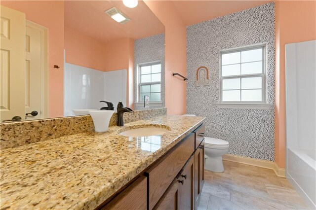 200 Cotton Ln, Hammond, LA 70401 - full bath with toilet, a tub, vanity, baseboards, and a shower
