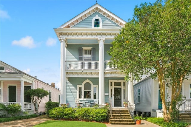 view of front of house featuring covered porch and a balcony