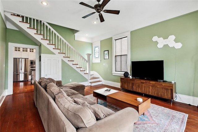 living area with stairs, a ceiling fan, baseboards, and recessed lighting