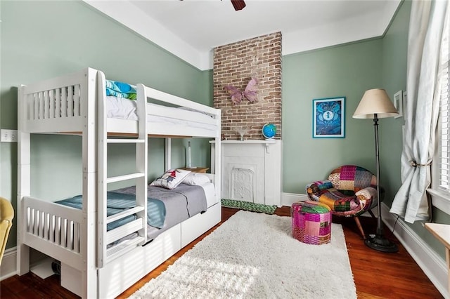 bedroom with wood finished floors, baseboards, and ceiling fan