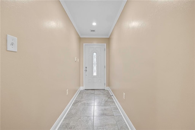doorway with baseboards and crown molding