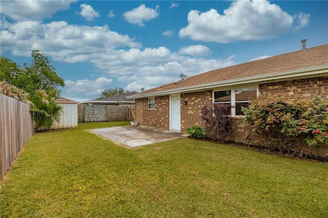 rear view of house with a storage unit, a patio, an outdoor structure, and brick siding