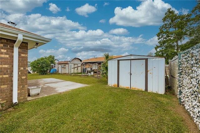 view of yard with a patio area, a shed, an outdoor structure, and a residential view