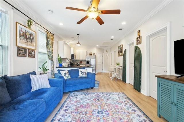 3222 Orleans Ave, New Orleans, LA 70119 - living room with ornamental molding, light wood-type flooring, ceiling fan, recessed lighting, and baseboards