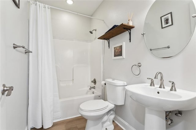 3222 Orleans Ave, New Orleans, LA 70119 - full bath with toilet, wood finished floors, shower / bathtub combination with curtain, a sink, and baseboards