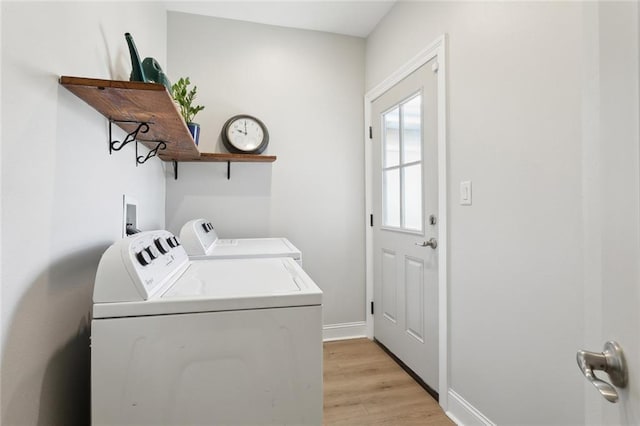 3222 Orleans Ave, New Orleans, LA 70119 - clothes washing area featuring washing machine and dryer, light wood-type flooring, and baseboards