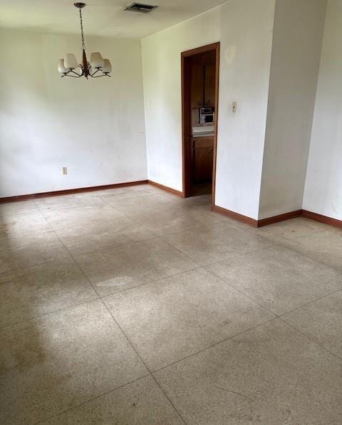 2258 General Collins Ave, New Orleans, LA 70114 - empty room featuring a chandelier and baseboards