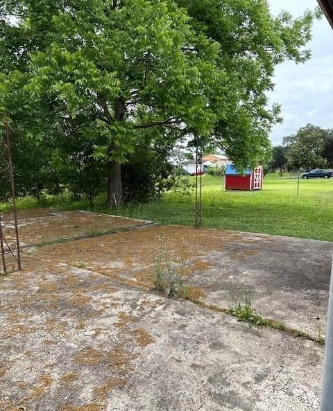 2258 General Collins Ave, New Orleans, LA 70114 - view of green lawn with a storage shed and an outbuilding