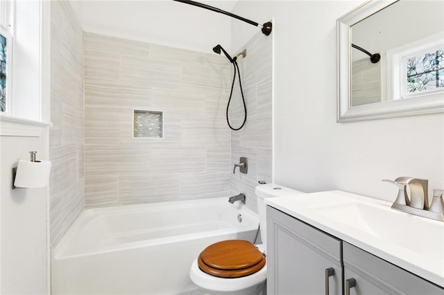 full bathroom with bathtub / shower combination, vanity, and toilet