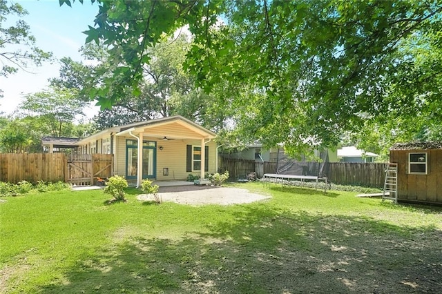 527 S Filmore St, Covington, LA 70433 - rear view of property with a trampoline, a patio, and a gate