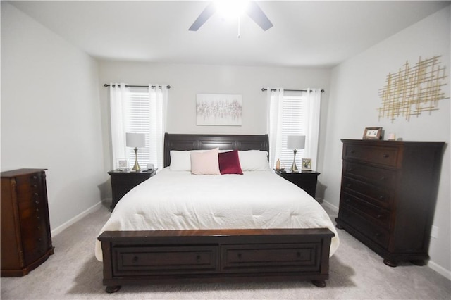 bedroom featuring multiple windows, light colored carpet, and baseboards