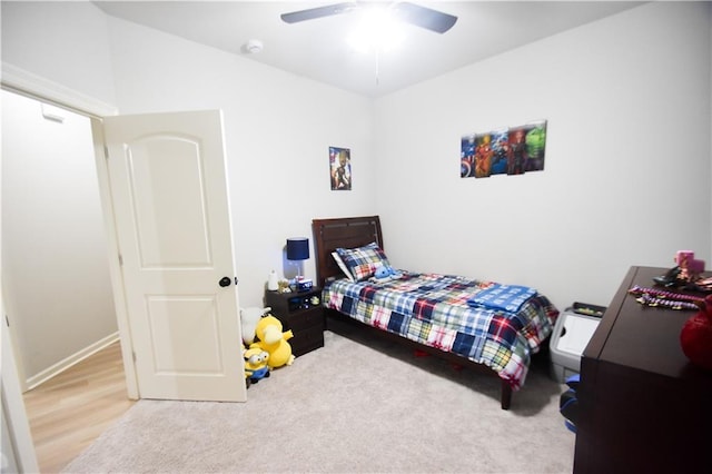 carpeted bedroom featuring ceiling fan and baseboards