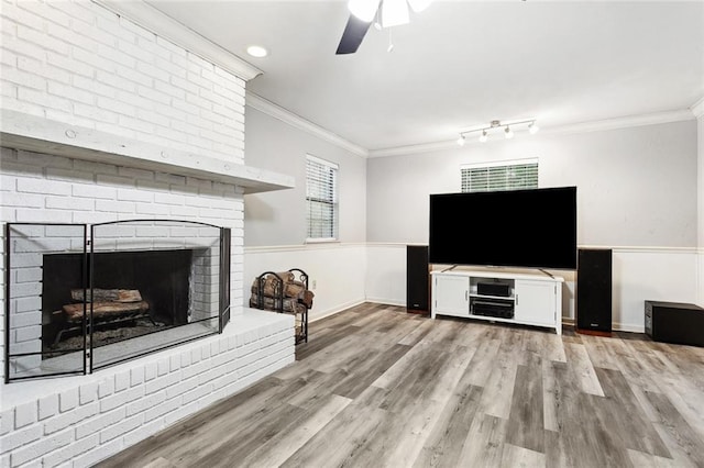 19635 Sunshine Ave, Covington, LA 70433 - living area with a fireplace, ornamental molding, a ceiling fan, and wood finished floors