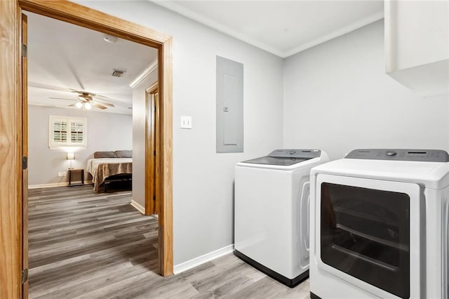 19635 Sunshine Ave, Covington, LA 70433 - laundry room with electric panel, washing machine and dryer, light wood finished floors, crown molding, and ceiling fan
