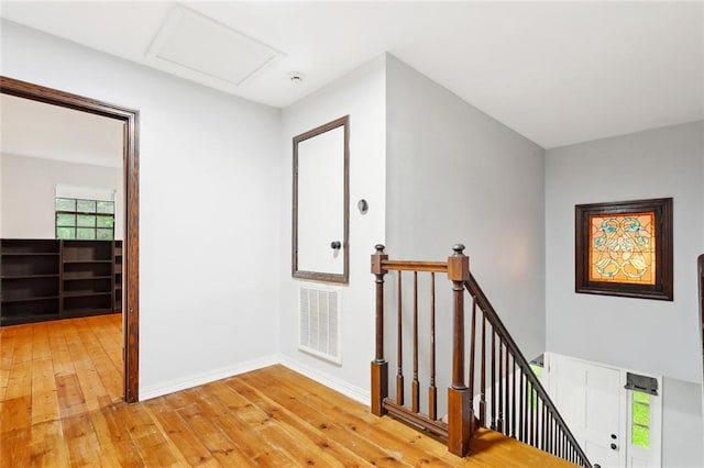 19635 Sunshine Ave, Covington, LA 70433 - hallway featuring an upstairs landing, light wood finished floors, and attic access