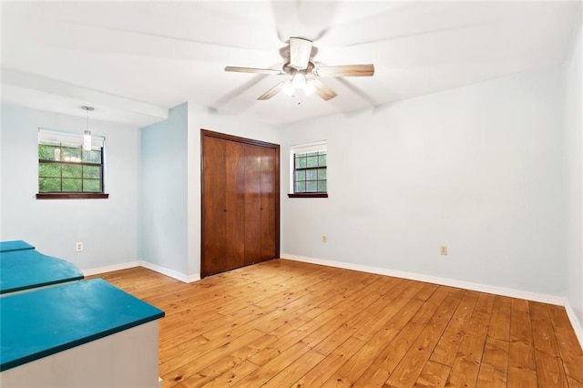 19635 Sunshine Ave, Covington, LA 70433 - unfurnished bedroom featuring light wood-style flooring, multiple windows, and a closet