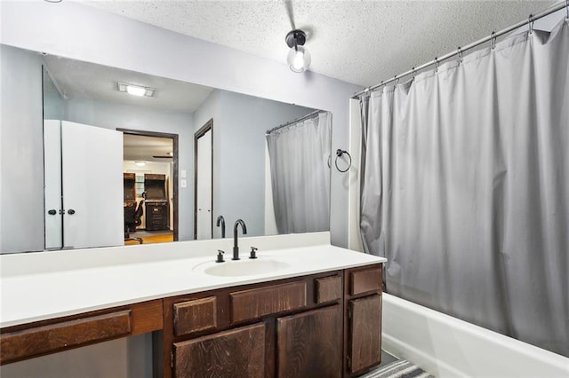 19635 Sunshine Ave, Covington, LA 70433 - bathroom featuring shower / bath combination with curtain, vanity, and a textured ceiling